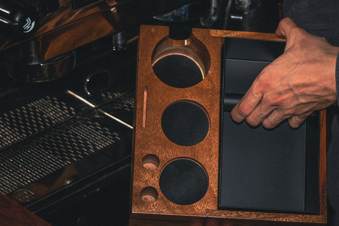 Tamping station being held near espresso machine