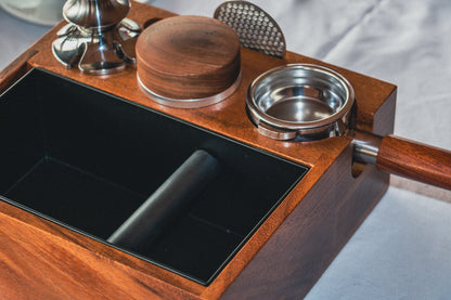 Tamping station with knock box